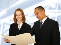 bigstockphoto_Business_Team_Reviewing_Folder_2919634